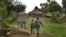 In this July 14, 2017 photo, Myanmar Border Guard Police (BGP) officers walk along a path in Tin May village, in which Myanmar government and military claim the existence of Muslim terrorists in Rakhine State, Myanmar.