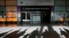 FILE - Peoples' shadows are projected onto the ground as an international traveler arrives at Logan Airport in Boston, Massachusetts, Jan. 30, 2017.