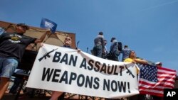 Demonstrators hold a banner to protest the visit of President Donald Trump to the border city after the Aug. 3 mass shooting in El Paso, Texas, Aug. 7, 2019. 