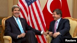 U.S. Secretary of State John Kerry (L) meets with Turkey's Foreign Minister Ahmet Davutoglu before attending the Association of Southeast Asian Nations (ASEAN) security meetings in Bandar Seri Begawan, July 2, 2013. 