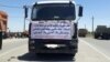 A truck in the northern Iranian city of Qazvin displays a sign of a striking trucker driver on May 28, 2018. The sign reads: “We are protesting the unprecedented high prices for spare parts and tires...”