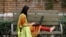 FILE - A student works on her computer sitting on a bench at Shaheed Benazir Bhutto Women's University in Peshawar, Pakistan, Oct. 19, 2017. 