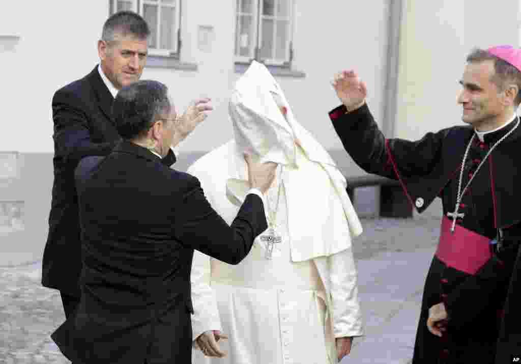 A gust of wind blows Pope Francis' mantle as he arrives for a meeting with people assisted by the church, at the Cathedral of Saints Peter and Paul in Tallinn, Estonia.