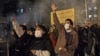 FILE - Protesters chant slogans and hold a placard reading in Farsi "Your mistake was unintentional, your lie was intentional," during an anti-government rally outside Amir Kabir University, in Tehran, Iran, Jan. 11, 2020.
