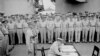 FILE - General Douglas MacArthur signs as Supreme Allied Commander during Japan's formal surrender ceremonies on the battleship USS Missouri in Tokyo Bay, Sept. 2, 1945. (Lt. C. F. Wheeler/US Navy/Handout via Reuters)