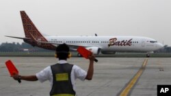 Marsekal bandara mengarahkan jetliner Batik Air di landasan selama upacara peluncuran maskapai di Bandara Internasional Soekarno-Hatta di Jakarta, Indonesia, Kamis, 25 April 2013. Lion Air meluncurkan Batik Air. (Foto: AP / Achmad Ibrahim)