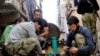 Citizen journalism image provided by Aleppo Media Center AMC which has been authenticated based on its contents and other AP reporting, shows members of the free Syrian Army preparing their weapons, April 25, 2013.