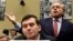 Benjamin Brafman, right, attorney for pharmaceutical chief Martin Shkreli, foreground, speaks on Capitol Hill in Washington, Feb. 4, 2016, during a House Committee on Oversight and Reform Committee hearing on rising drug prices. 