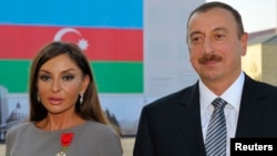 FILE - Azerbaijan's President Ilham Aliev (R) and first lady Mehriban Aliyeva pose after she was awarded with the Legion d'Honneur medal in Baku.