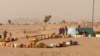 Refugees set out containers waiting for UNHCR to fill them with water, at Minawao refugee camp, northern Cameroon, Feb. 9 2018. (M. Kindzeka/VOA)