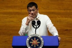 Philippine President Rodrigo Duterte gestures as he delivers his annual state of the nation address at the House of Representatives in Manila on July 26, 2021. (Photo by LISA MARIE DAVID / POOL / AFP)