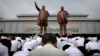 North Koreans bow in front of bronze statues of the late leaders Kim Il Sung, left, and Kim Jong Il at Munsu Hill in Pyongyang, North Korea, July 27, 2015. These two bronze statues were created by artists from Mansudae Art Studio.