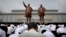 North Koreans bow in front of bronze statues of the late leaders Kim Il Sung, left, and Kim Jong Il at Munsu Hill in Pyongyang, North Korea, July 27, 2015. These two bronze statues were created by artists from Mansudae Art Studio.