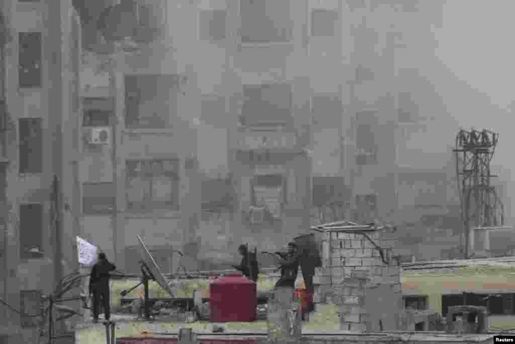 Free Syrian Army members raise an Islamic flag on a rooftop after heavy fighting with President Bashar al-Assad's forces, in the Jobar area of Damascus, Syria, Feb. 6, 2013. 
