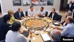 Para pemimpin negara-negara G8 dalam KTT di Irlandia Utara. Dari kiri searah jarum jam: Kanselir Jerman Angela Merkel (berbaju hijau), Presiden Rusia Vladimir Putin, PM Inggris David Cameron, Presiden AS Barack Obama, Presiden Perancis Hollande, dan para pemimpin G8 di Lough Erne, dekat Enniskillen, Irlandia Utara (18/6).