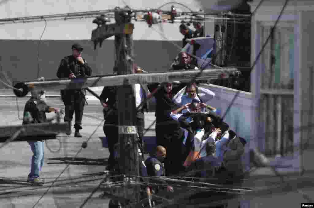 People are evacuated in the area of a deadly shooting incident at a United Parcel Service (UPS) facility in San Francisco, California.