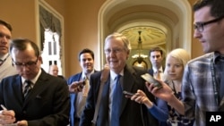 Senate Minority Leader Mitch McConnell of Kentucky, center, arrives at his office in the Capitol as he and Senate Majority Leader Harry Reid of Neveda try to negotiate a legislative solution to avoid the so-called "fiscal cliff", Sunday, December 30, 2012.