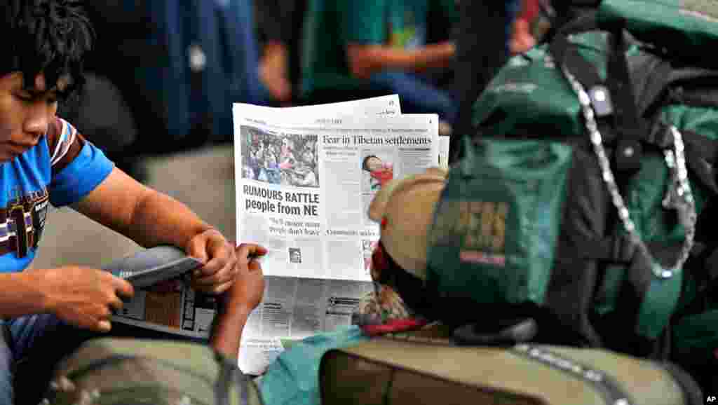 A mans at the train stations reads about people leaving the city.