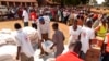 FILE - Displaced Kenyans stand in line for food and material relief at a school in Busia in eastern Uganda at the border of Kenya, Jan. 15, 2008. Fearing violence in connection with Tuesday's elections, this time again, some Kenyans have crossed the border.