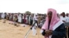 Senior al-Shabab officer Sheikh Hassan Dahir Aweys leads faithful in prayers on the first day of Eid al-Adha in Somalia's capital Mogadishu November 6, 2011.