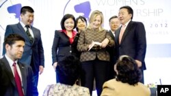 Indian schoolchildren use a plastic sheet to keep dry as they ride a cycle-rickshaw during a light drizzle in New Delhi. 