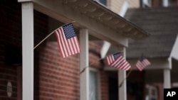 FILE - Flags are posted on the home of Keonna Thomas, accused of trying to join and martyr herself for the Islamic State group in Syria, April 3, 2015, in Philadelphia, Pennsylvania.