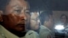 Ny Chakrya, second from left, former ADHOC and a National Election Committee member who worked at the organization, sits in a car and is transported back to an Anti-Corruption Unit, ACU, after a short appearance at Phnom Penh Municipal Court, in Phnom Penh, Cambodia, Saturday, April 30, 2016. 