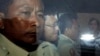 Ny Chakrya, second from left, former ADHOC and a National Election Committee member who worked at the organization, sits in a car and is transported back to an Anti-Corruption Unit, ACU, after a short appearance at Phnom Penh Municipal Court, in Phnom Penh, Cambodia, Saturday, April 30, 2016. Cambodian authorities arrested five human rights workers last Friday on accusations they tried to help cover up a woman's affair with the deputy leader of the opposition Cambodia National Rescue Party. The action is the latest in a series by Prime Minister Hun Sen's government putting legal pressure on its critics and political opponents. (AP Photo/Heng Sinith)