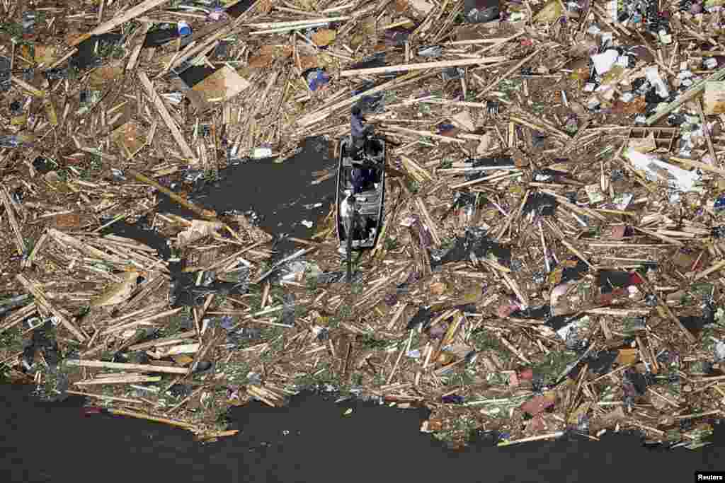 Tim SAR melakukan pencarian di antara reruntuhan di sebuah danau, setelah tornado menghantam permukiman di kota Vilonia, negara bagian Arkansas, AS.