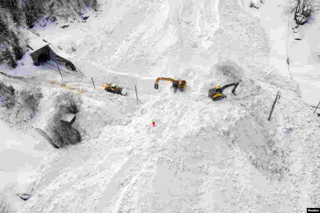 Excavators remove the snow on the site of an avalanche that covered the railway of the Brig Visp Zermatt Bahn company between Visp and Taesch 8, near Sankt Niklaus, Swiss Alps.