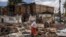 A woman walks past debris from houses during a planned demolition in the historical Piazza neighbourhood of Addis Ababa on March 14, 2024.