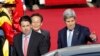 U.S. Secretary of State John Kerry, right, and U.S. Ambassador to South Korea Mark Lippert walk to a car upon his arrival from China, at the Seoul Military Airport in Seongnam, South Korea, May 17, 2015. (