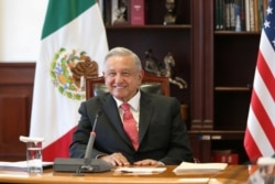 Mexico's President Manuel Lopez Obrador listens from the National Palace in Mexico City, Mexico, during a virtual bilateral meeting with U.S. President Joe Biden, who is in Washington, March 1, 2021. (Mexico's Presidency Office/Handout via Reuters)