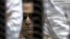 In this video image taken from Egyptian State Television, 84-year-old former Egyptian president Hosni Mubarak is seen in the defendant's cage as a judge reads the verdict in on charges of complicity in the killing of protesters during last year's uprising