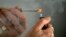 FILE - A person lights a cigarette.