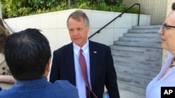 法庭为伊凯卡·康指定的辩护律师在法院外回答记者问题 (2017年7月10日)