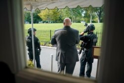 U.S. Secret Service Police stand outside the James Brady Press Briefing Room at the White House, in Washington, as a news conference by President Donald Trump was paused, Aug. 10, 2020.