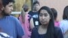 Edith Galvan, an undocumented immigrant and DACA recipient, talks to people at a small protest outside the county jail in Raleigh, North Carolina. It was the first protest organized by the Meredith College student. (A. Barros, VOA)