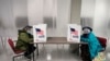 Two voters fill out ballots during early voting at the Cuyahoga County Board of Elections, Oct. 6, 2020, in Cleveland.