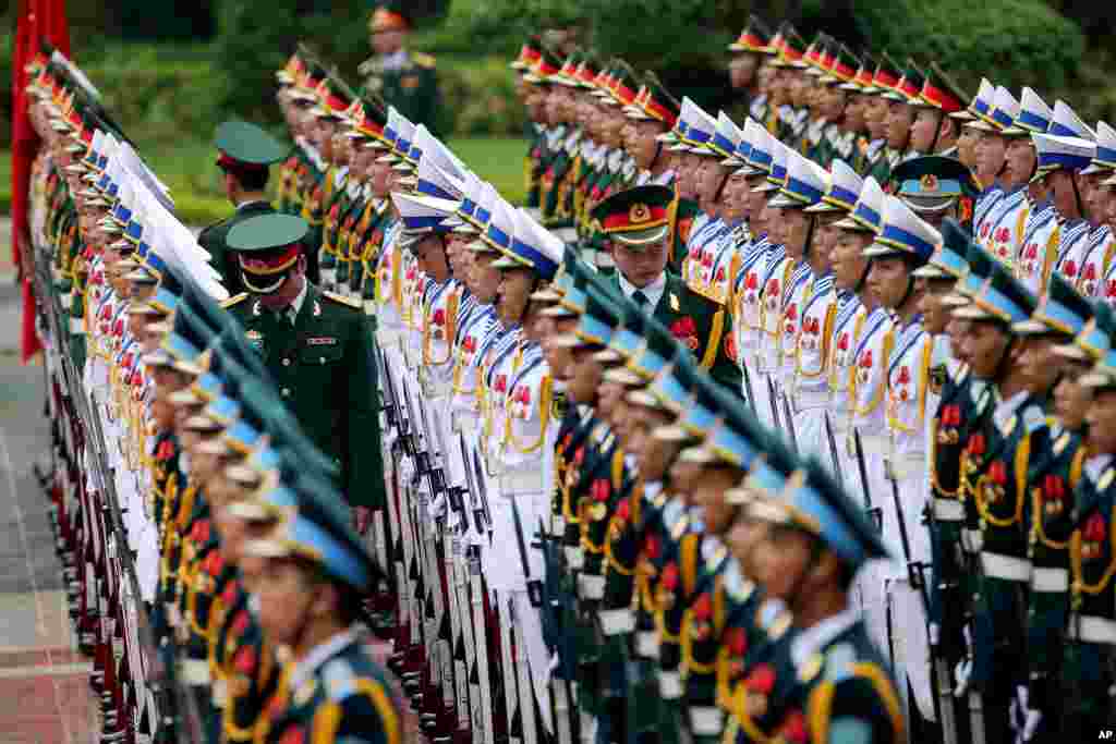 Members of the honor guard prepare for the arrival of France&#39;s President Francois Hollande at the Presidential Palace in Hanoi, Vietnam.