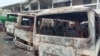 FILE - Burned buses are seen at the bus terminal in Buea, Cameroon, July 10, 2018. Gunfire broke out in the capital of a western region of Cameroon gripped by violence between anglophone separatists and security forces.
