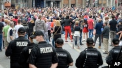 People attend an anti-Nazi protest outside Sacred Heart Cathedral during a Mass commemorating members of the pro-Nazi Croatian WWII Ustasha regime who were killed at the end of WWII by Yugoslav communist troops, in Sarajevo, Bosnia, May 16, 2020.
