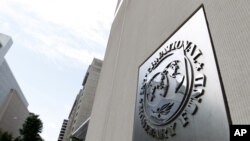 FILE - International Monetary Fund headquarters building in Washington.