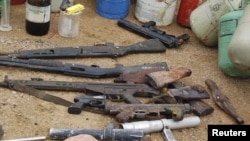 Confiscated weapons are displayed after a military raid on a hideout of suspected Islamist Boko Haram members in Nigeria's northern city of Kano August 11, 2012.