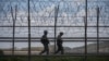 FILE - South Korean soldiers patrol along a barbed wire fence in the Demilitarized Zone (DMZ) separating North and South Korea, on the South Korean island of Ganghwa, April 23, 2020.