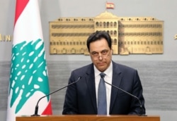 FILE - In this photo released by the Lebanese Government, Lebanese Prime Minister Hassan Diab, gives a speech at the Government House in Beirut, Lebanon, March. 7, 2020.