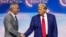 (FILES) Former US President and Republican presidential candidate Donald Trump (2nd L) shakes hands with US politician Robert F. Kennedy Jr. as he invites him former US Representative Tulsi Gabbard (R) and US commentator Tucker Carlson onto the stage duri