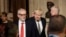 Britain's opposition Labour Party Leader Jeremy Corbyn, left, Prime Minister Boris Johnson, center right, walk through the Commons Members Lobby, during the state opening of Parliament, in London, Dec. 19, 2019.