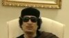 Muammar Gaddafi gestures as he speaks at a Tripoli hotel in this still image from a video by Libyan TV released May 11, 2011.
