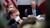 White House national security adviser Jake Sullivan, front, Secretary of State Antony Blinken, background-left, attend a meeting with President Joe Biden, right, in the Roosevelt Room of the White House, in Washington, March 1, 2021. 